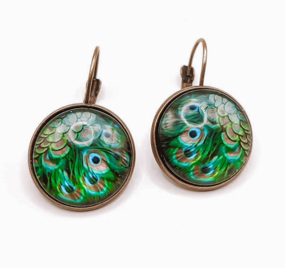 Pair of round vintage peacock-feather earrings, teal and green glass cabochons