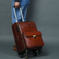 Brown leather carry-on trolley bag with front flap and top handle on four wheels