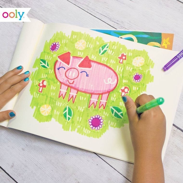 Erasable marker in use: green cap marker coloring a cartoon on paper