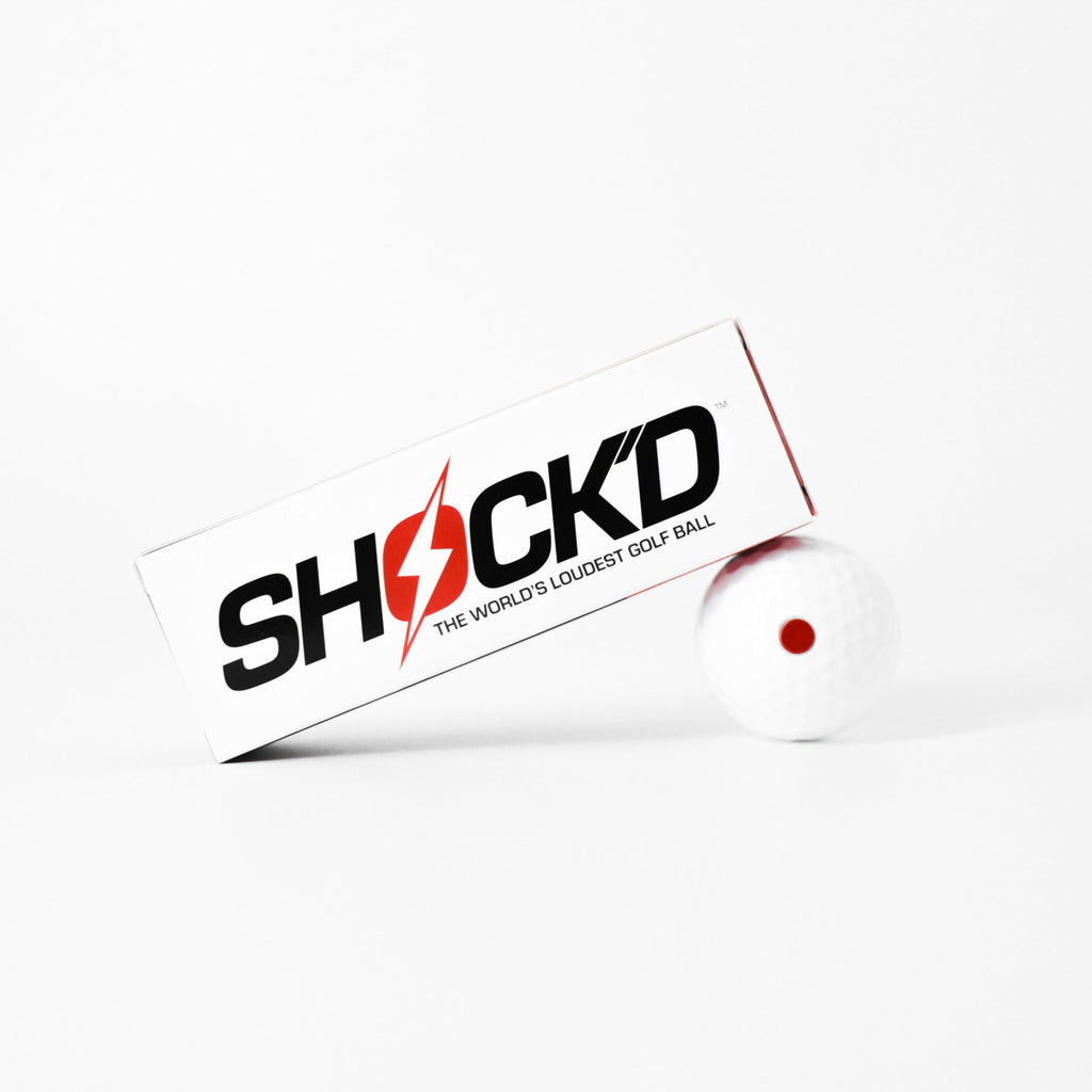 Shock'd golf ball box with red dot and one white golf ball