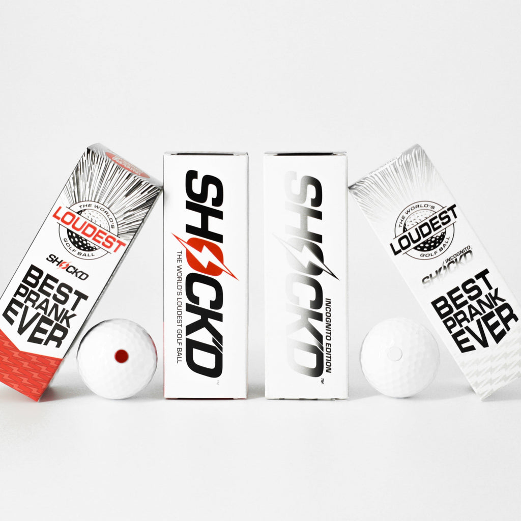 Golf ball multipack with Shock'd boxes and white golf balls with red dot