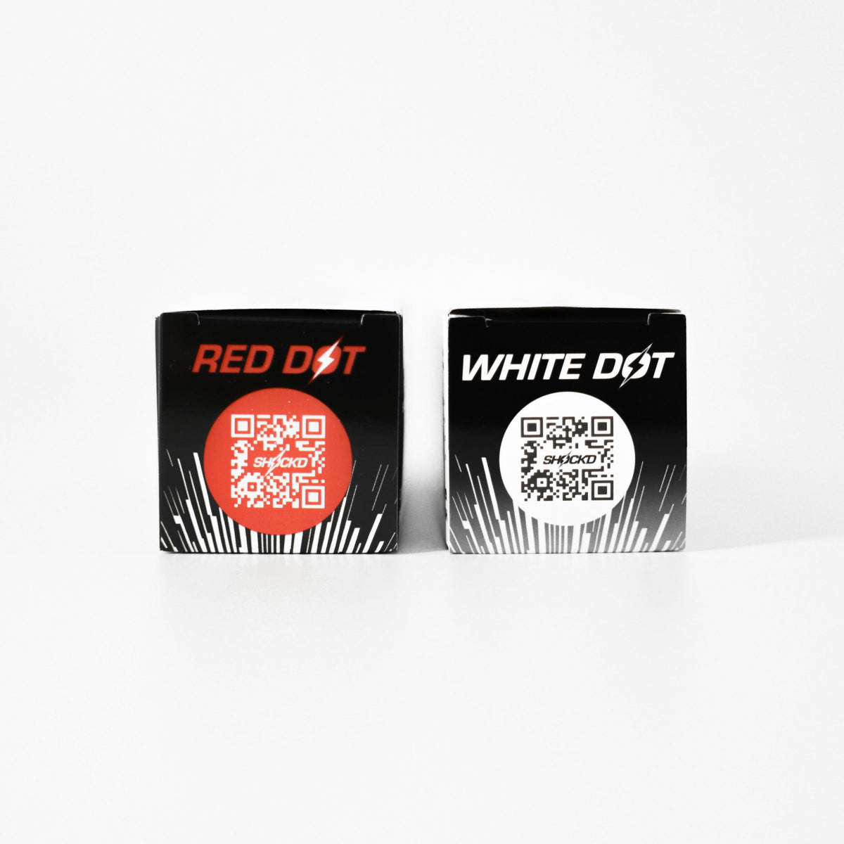 SHOCK'D RED DOT and WHITE DOT golf ball sleeves with QR codes on black packaging.