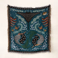 Navy celestial beach blanket with teal leaf and sea-creature eye motifs and fringe