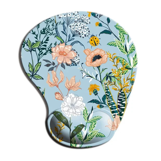 Ergonomic mouse pad wrist rest with light blue floral jungle print and curved wrist support