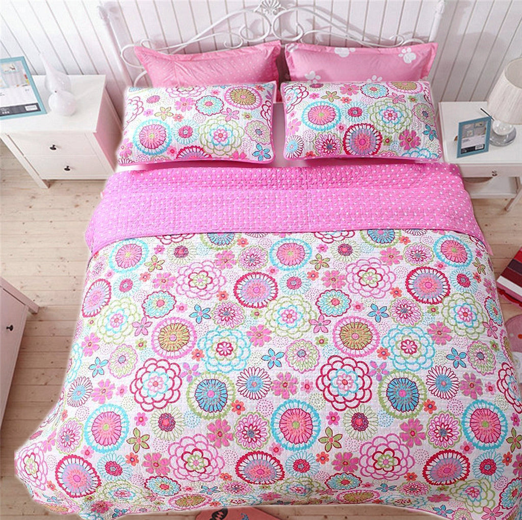 Reversible quilt bedding set shown on bed with floral quilt and matching shams