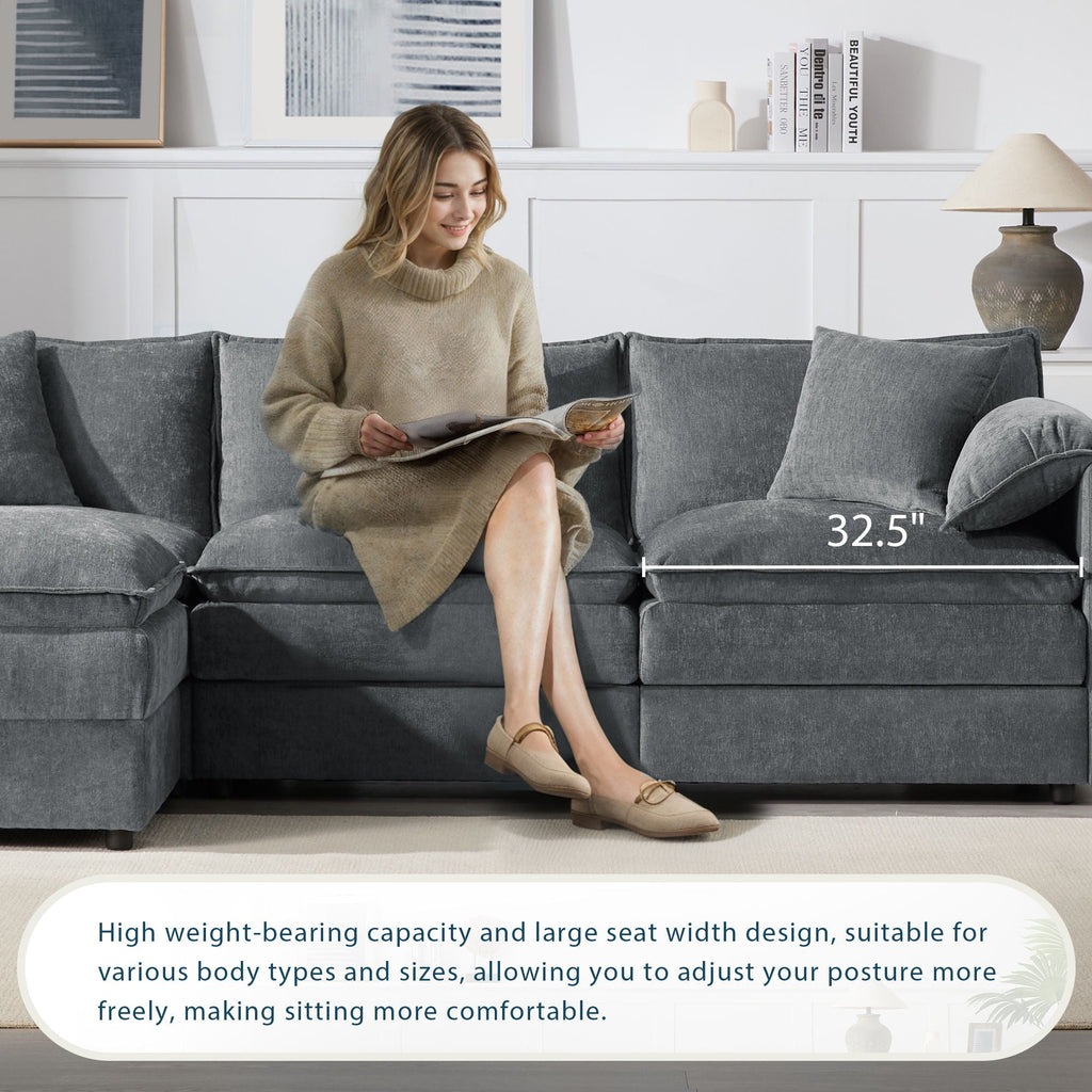 Dark gray sectional sofa with deep seat cushions, wide arms, and back pillows