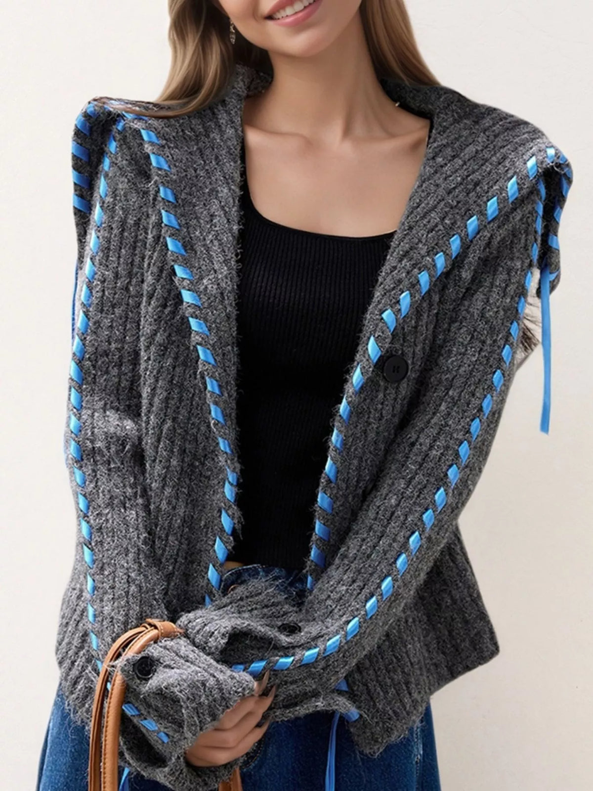 Gray ribbed knit open-front cardigan with blue trim, long sleeves, and black buttons