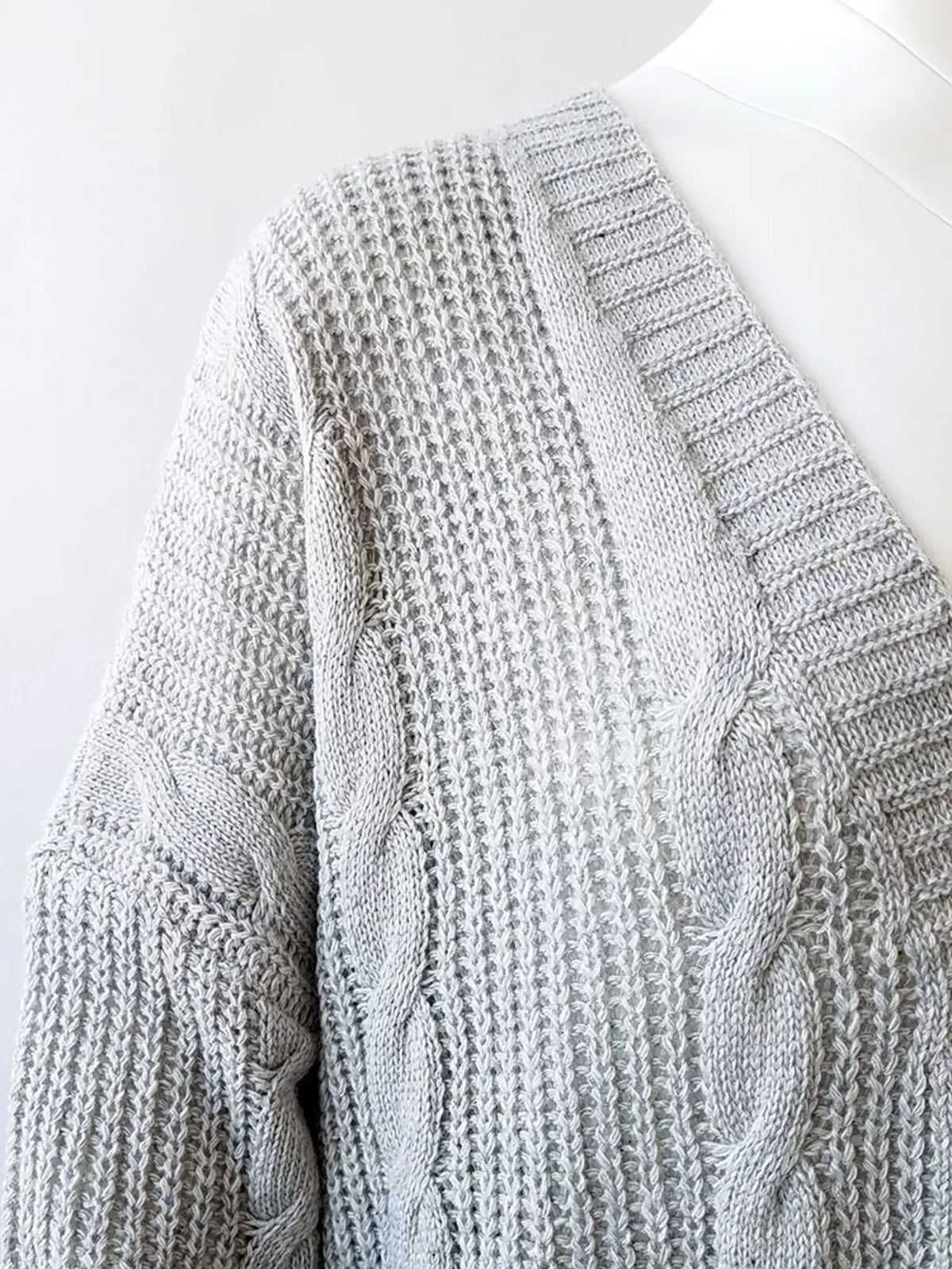 Plus-size chunky knit open-front cardigan, light gray with cable and ribbed knit detail.