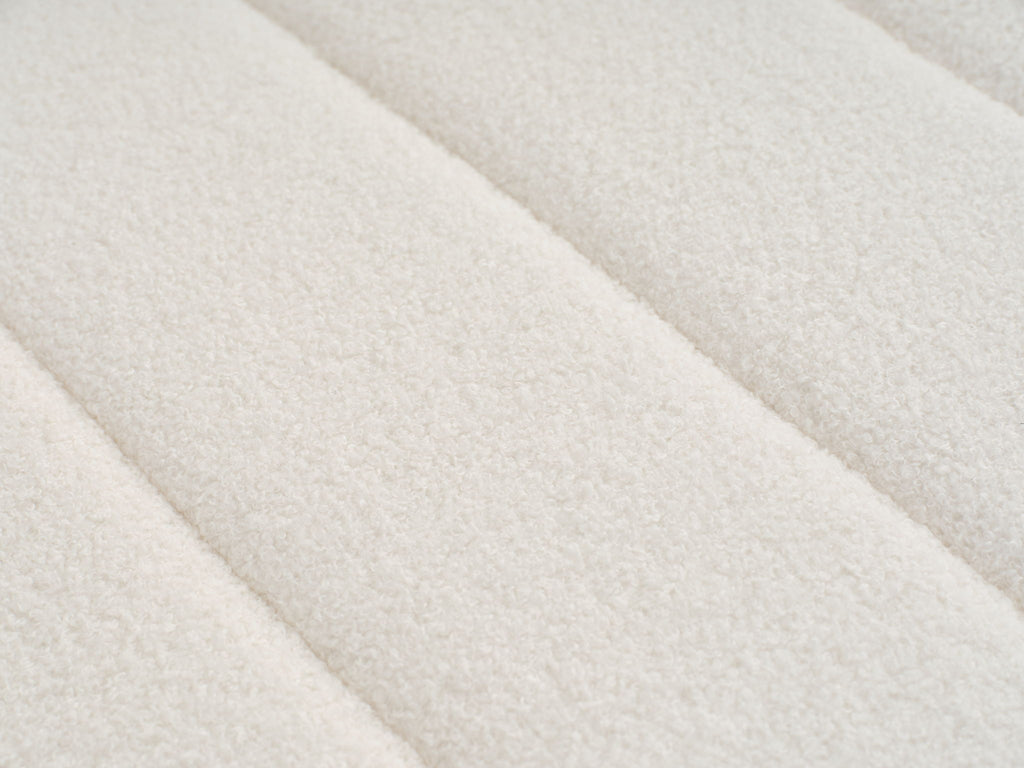 Beige lamb-wool upholstery fabric close-up with soft textured weave.