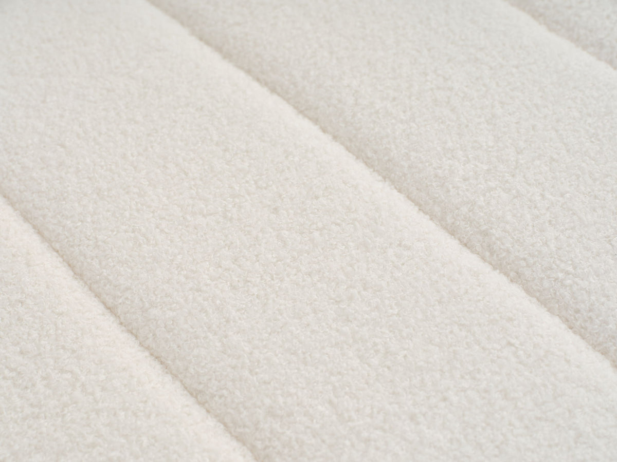 Beige lamb-wool upholstery fabric close-up with soft textured weave.