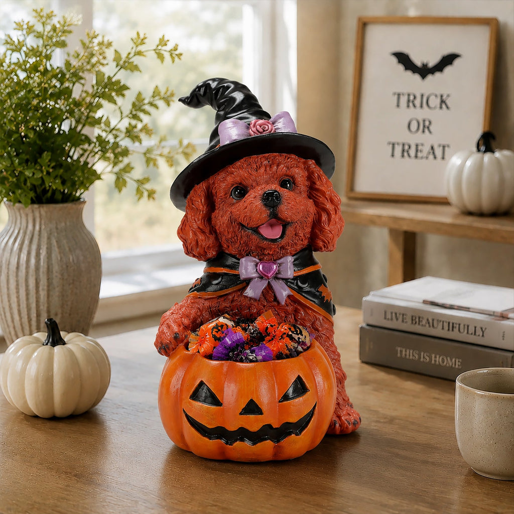 Brown teddy dog witch figurine holding a candy-filled jack-o'-lantern bowl