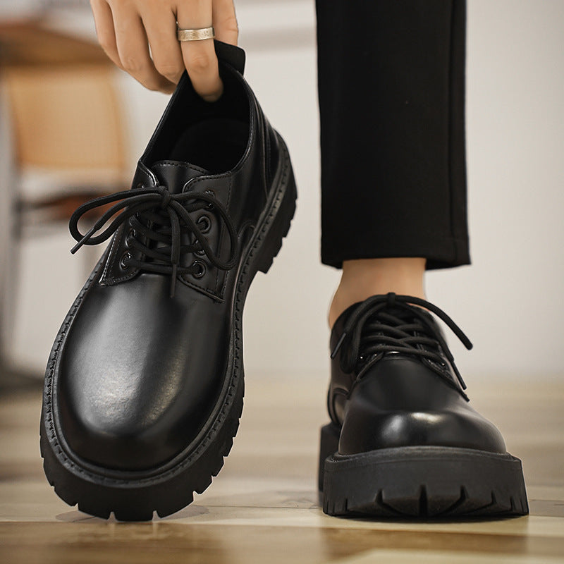 Black lace-up derby shoes worn with trousers, side view with chunky sole.