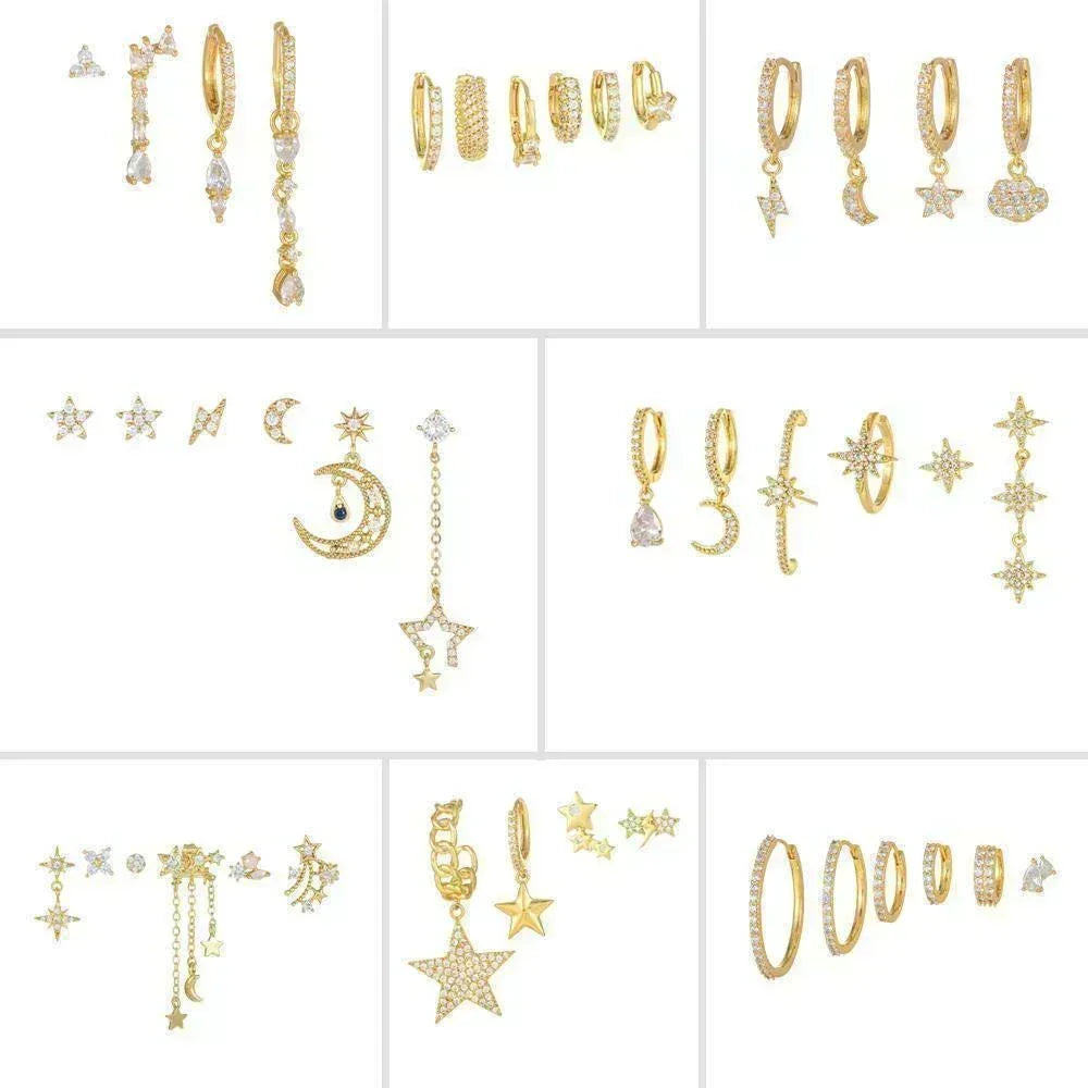 Assorted gold and zirconia star-and-moon dangling earrings displayed in a set layout.