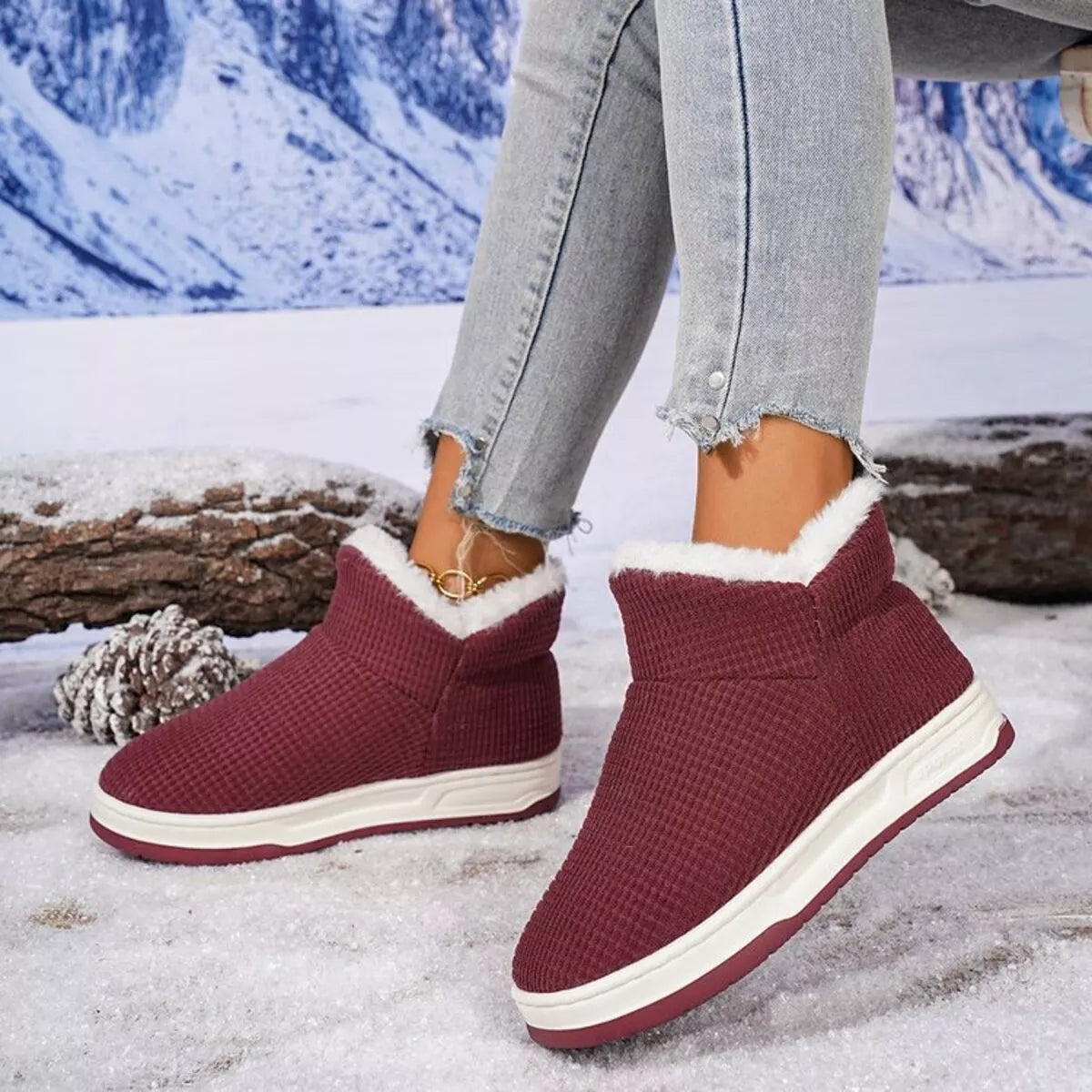 Burgundy knit ankle boots with plush white trim and low cream rubber sole
