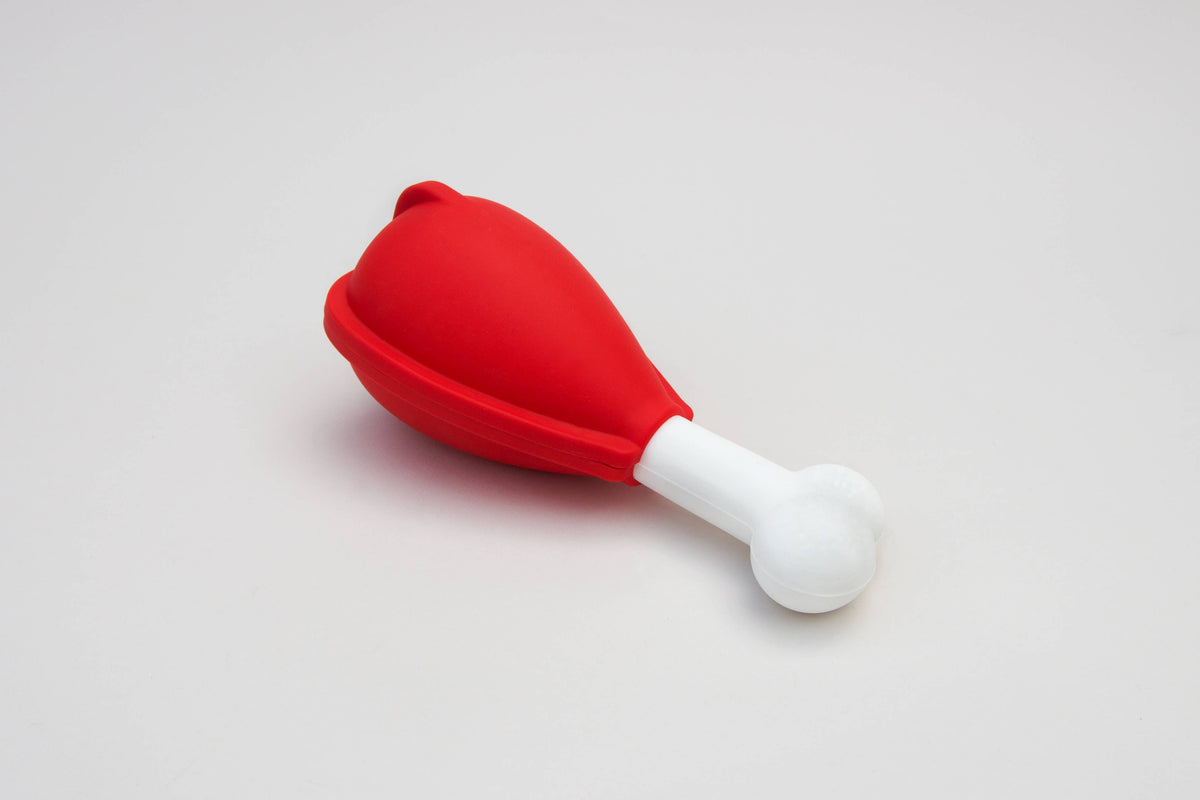 Assembled red dog ice lolly mold with a white bone-shaped handle