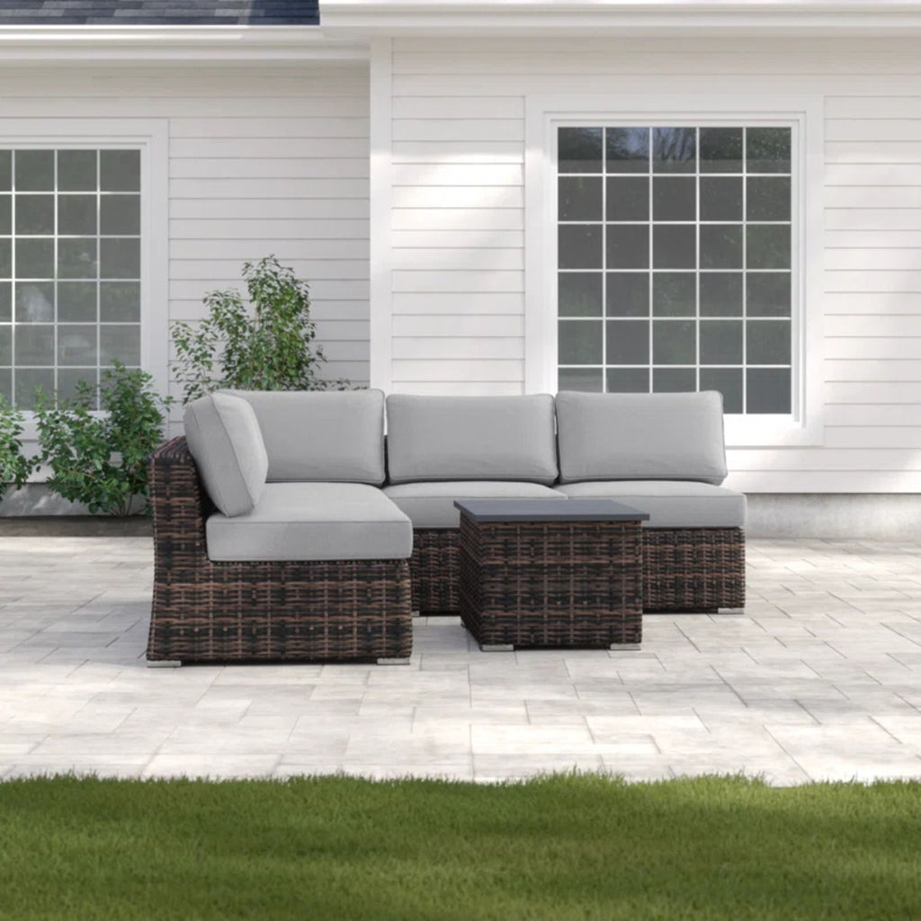 Dark brown wicker sectional sofa with light gray cushions and square coffee table