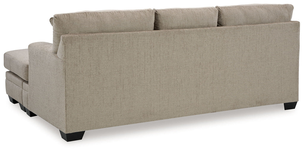 Stonemeade upholstered sofa with square arms and short dark legs in light beige