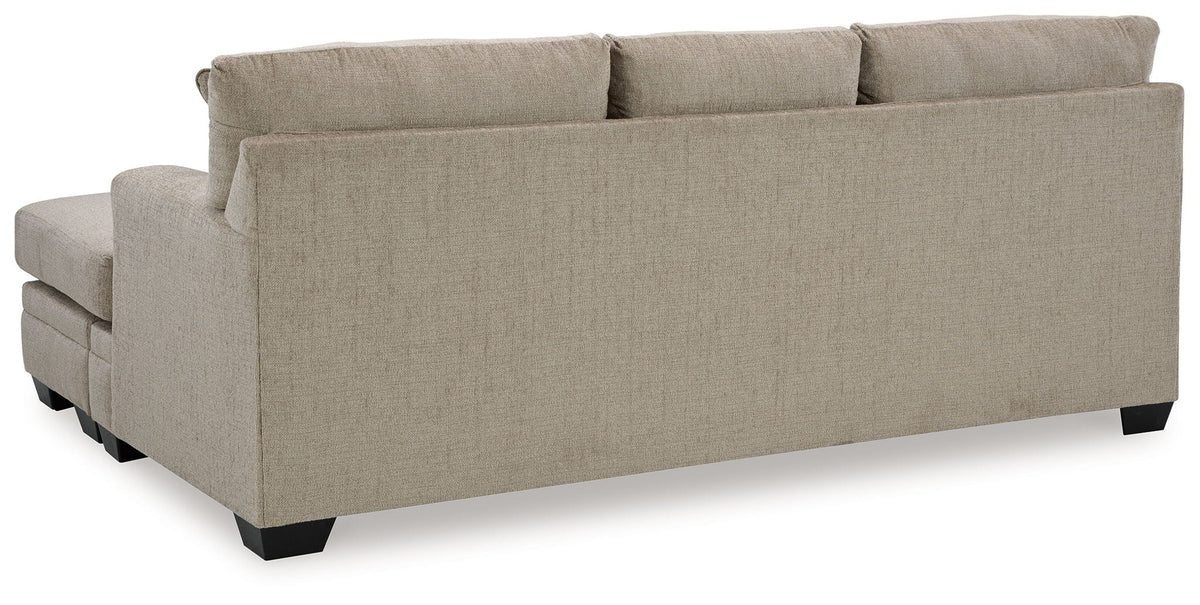 Stonemeade upholstered sofa with square arms and short dark legs in light beige