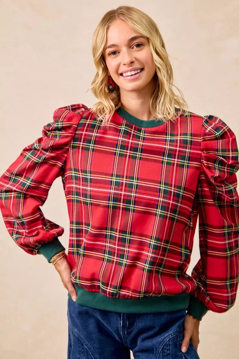 Red plaid top with exaggerated shoulder sleeves, long puffed sleeves, green hem