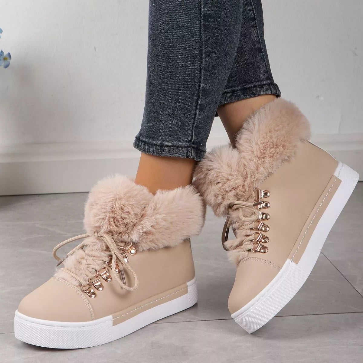 Beige fuzzy-collar lace-up ankle boots with gold eyelets and white rubber sole