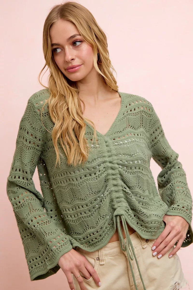 Sage green pointelle knit V-neck top with ruched front detail and long sleeves