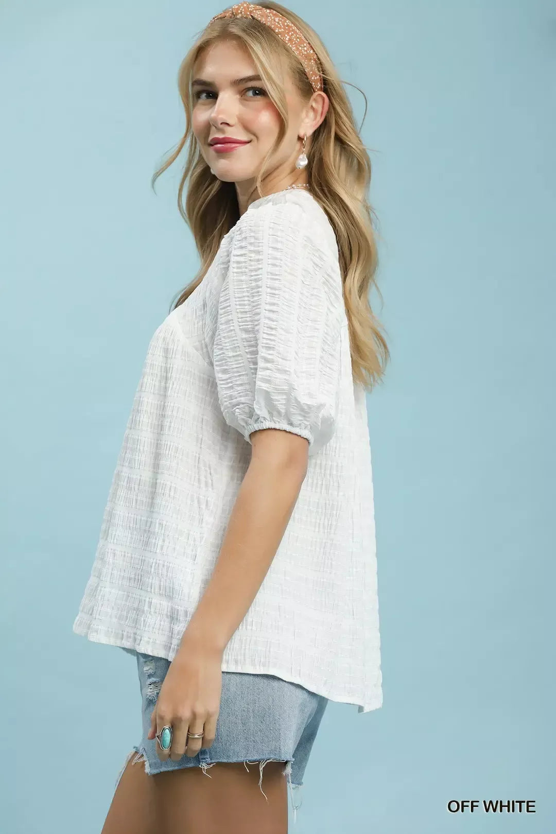 Off-white textured puff-sleeve blouse with short sleeves and V-neck