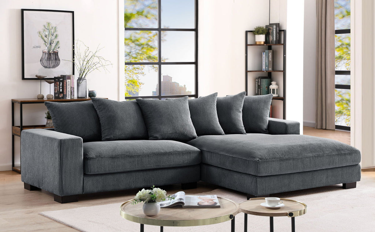 Dark gray L-shaped sectional sofa with chaise and five matching accent pillows.