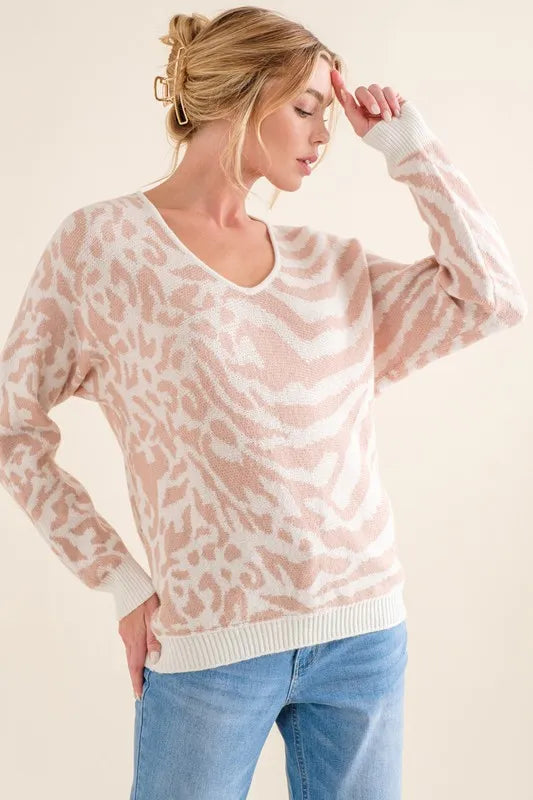 Pale pink V-neck knit sweater top with zebra and leopard pattern, long sleeves