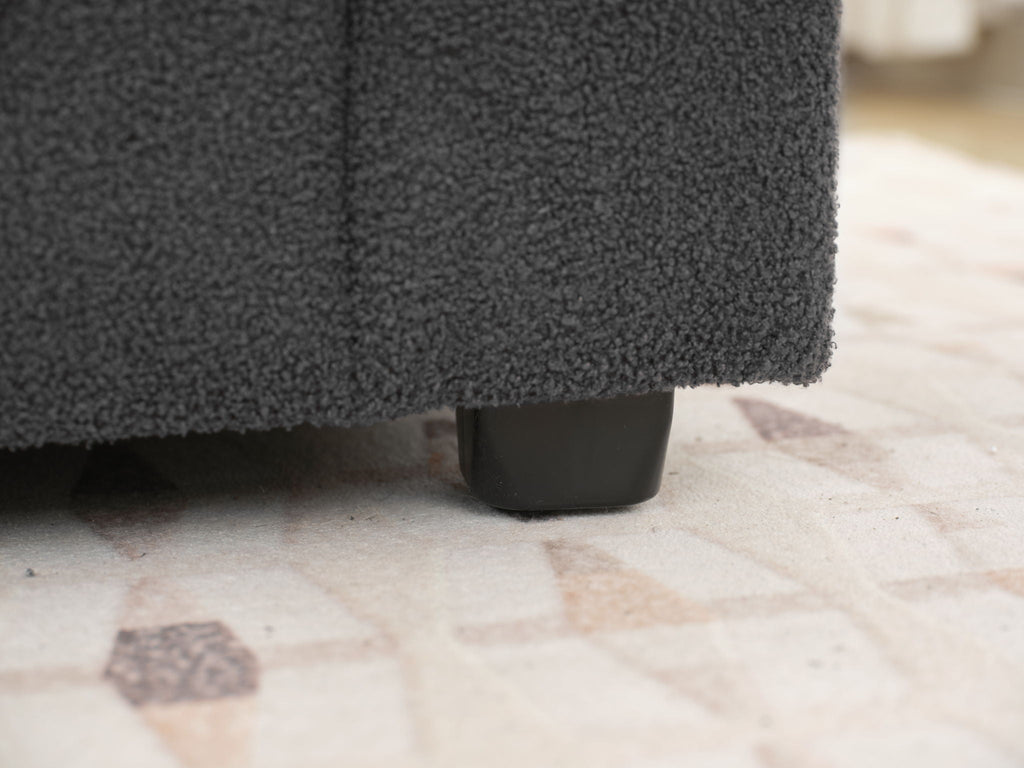 Dark gray sofa chaise leg and bottom edge detail