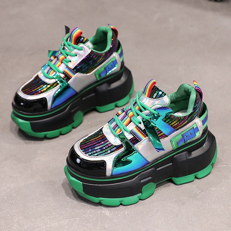 Green lace-up chunky sneakers with rainbow-striped laces, sequined panels, and black sole