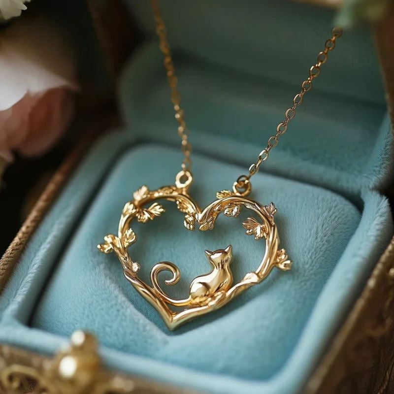 Gold cat heart pendant necklace with decorative curved filigree and raised outline