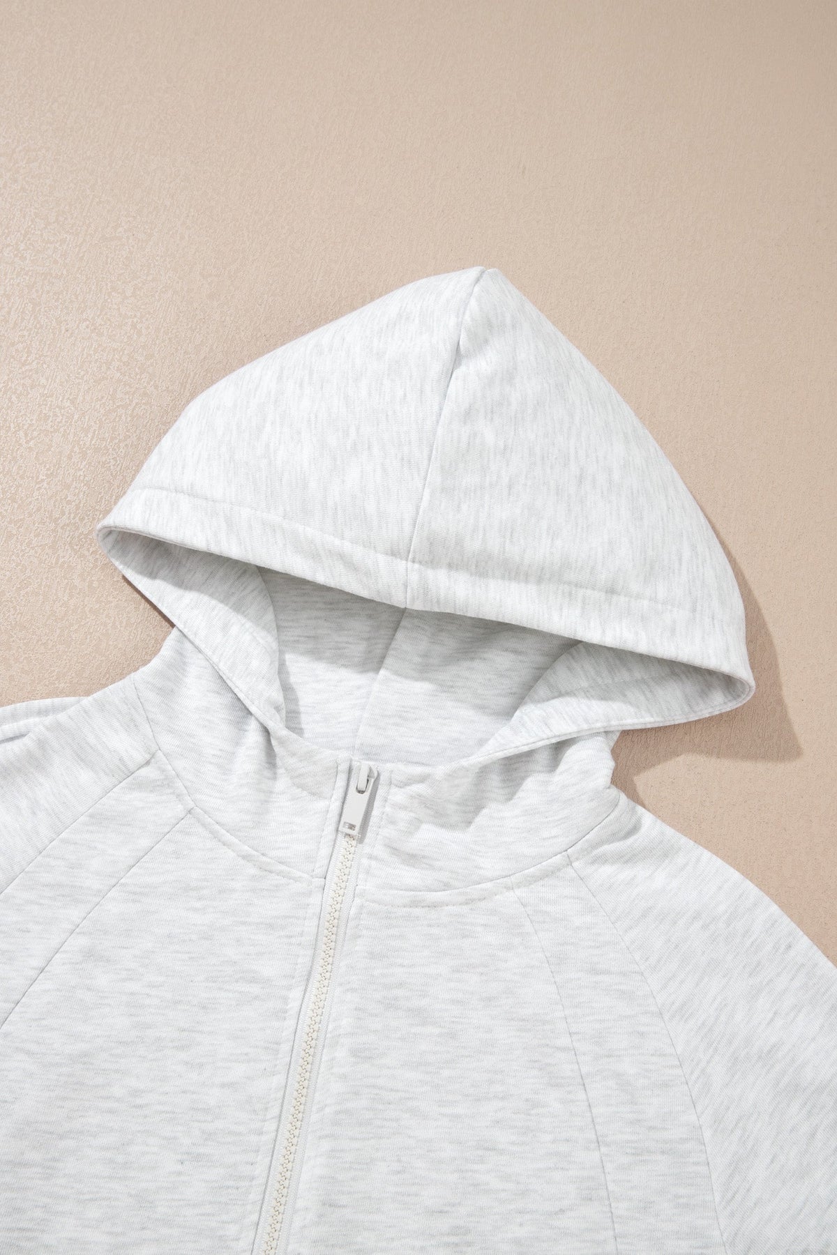 Light grey hooded zip-up top with full-length front zipper