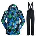 Men's hooded ski jacket and black bib pants, blue-green abstract winter pattern.