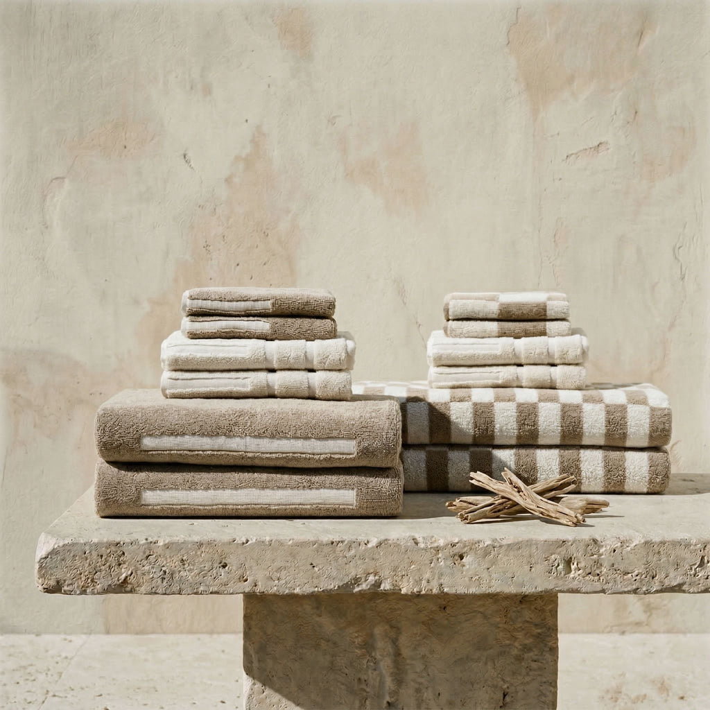 Australian cotton towels, stacked light neutral towels with one folded patterned towel
