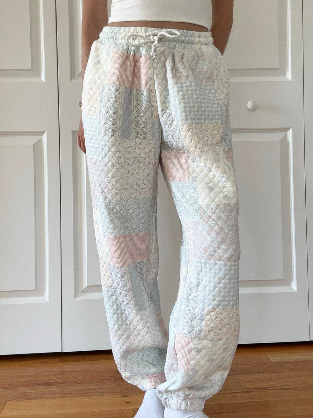 Quilted pastel jogger pants with patchwork-style light blue and pink diamond pattern