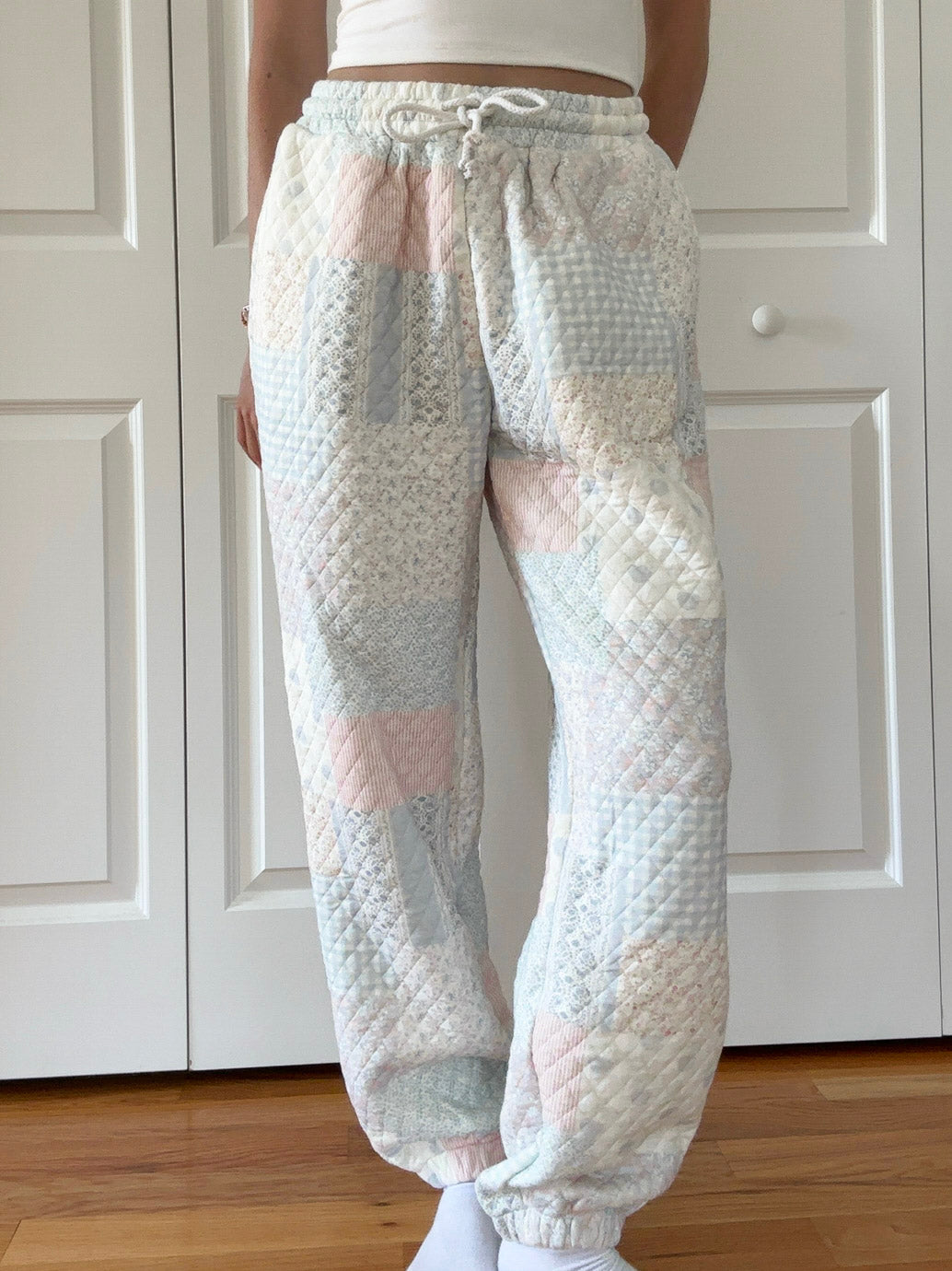Quilted pastel jogger pants with patchwork-style light blue and pink diamond pattern