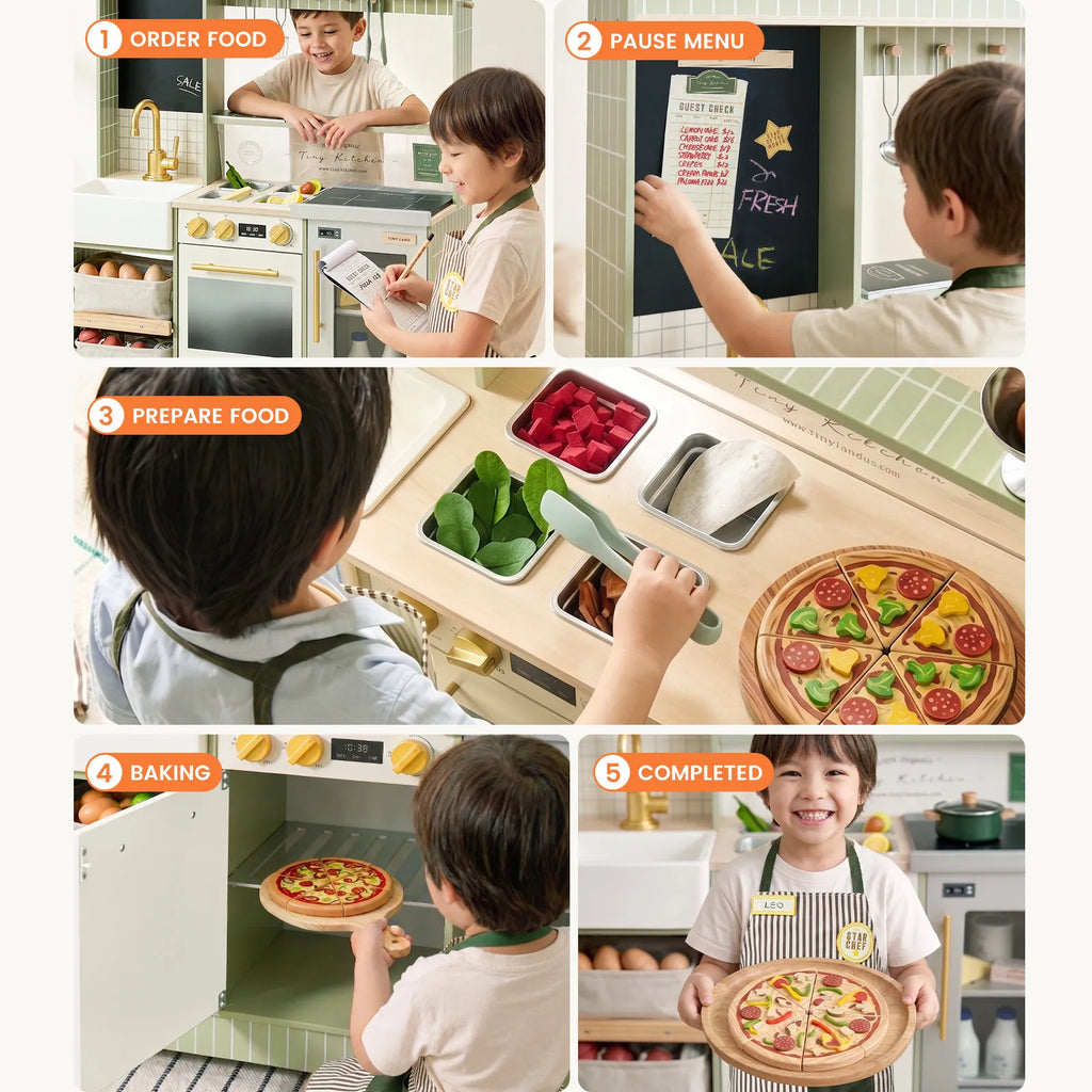 Kids playing at a green play kitchen with pizza, oven door, and prep storage trays.