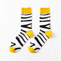 White crew socks with black zebra stripe pattern and yellow top cuff