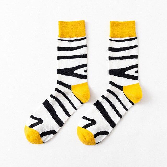 White crew socks with black zebra stripe pattern and yellow top cuff