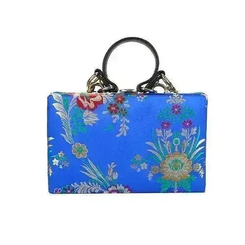 Blue floral clutch bag with multicolor botanical print and loop top handles
