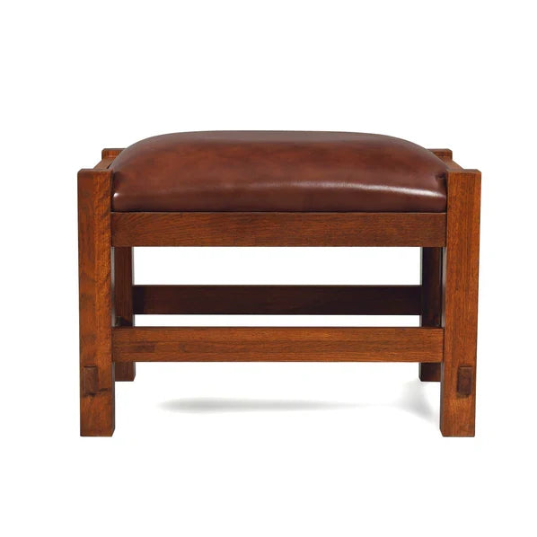 Chestnut leather ottoman stool with rounded padded seat and wood frame