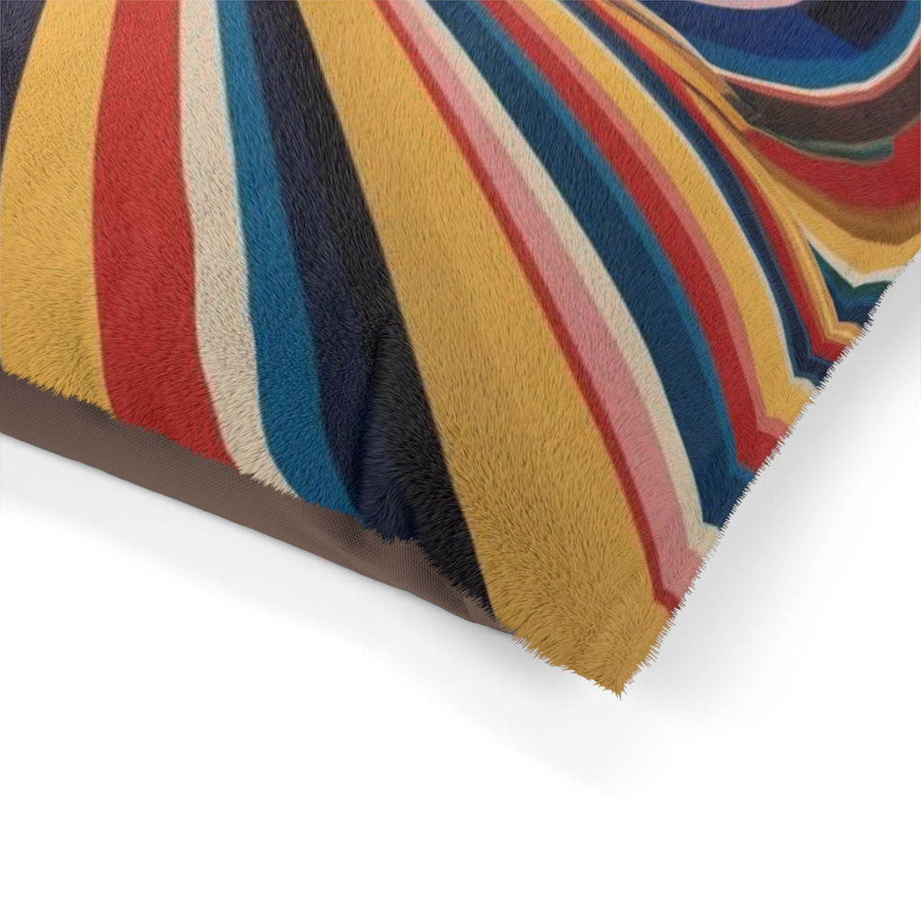 Corner close-up of multicolor striped plush pet bed with fringed trim