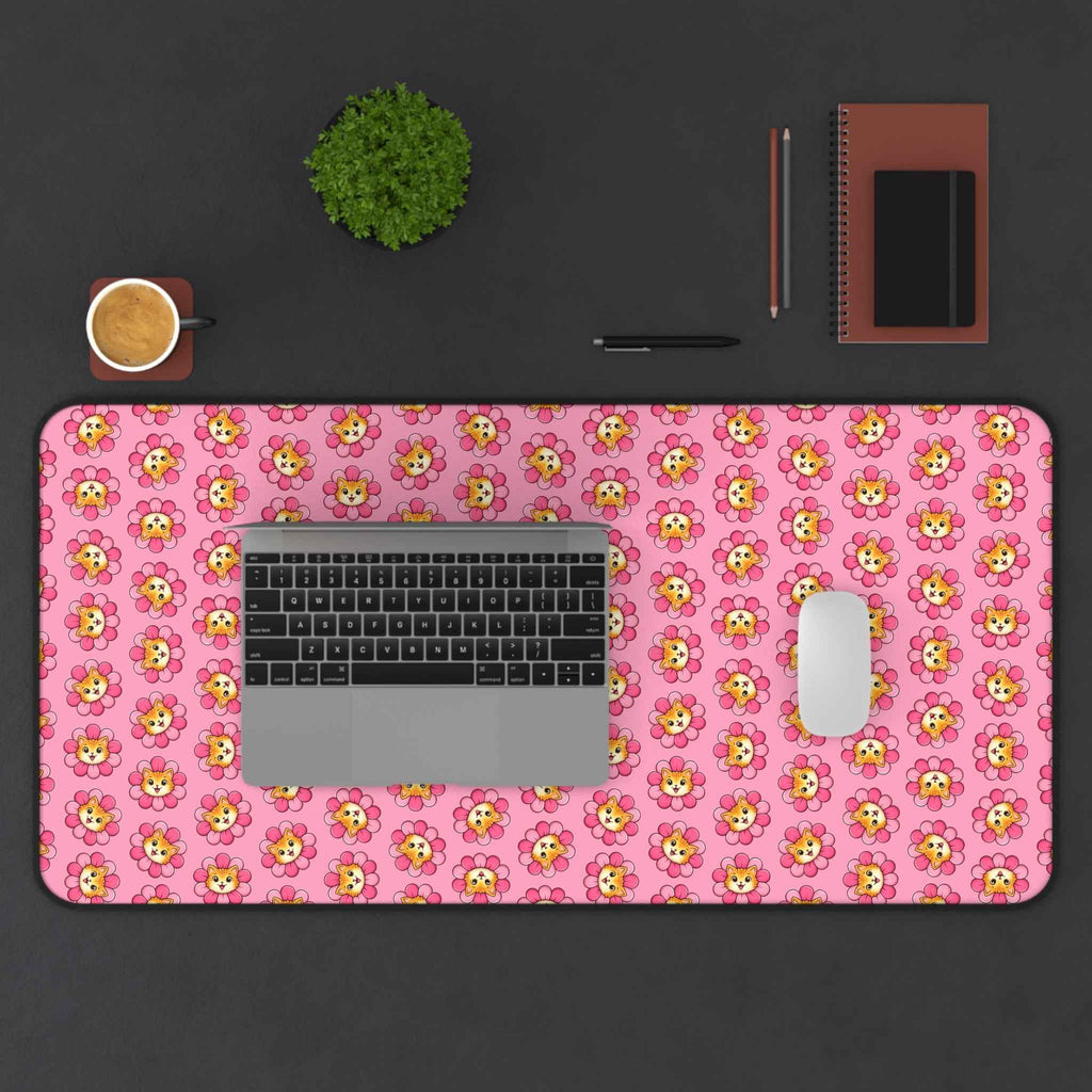 Pink desk mat with repeating cat pattern, rounded edges