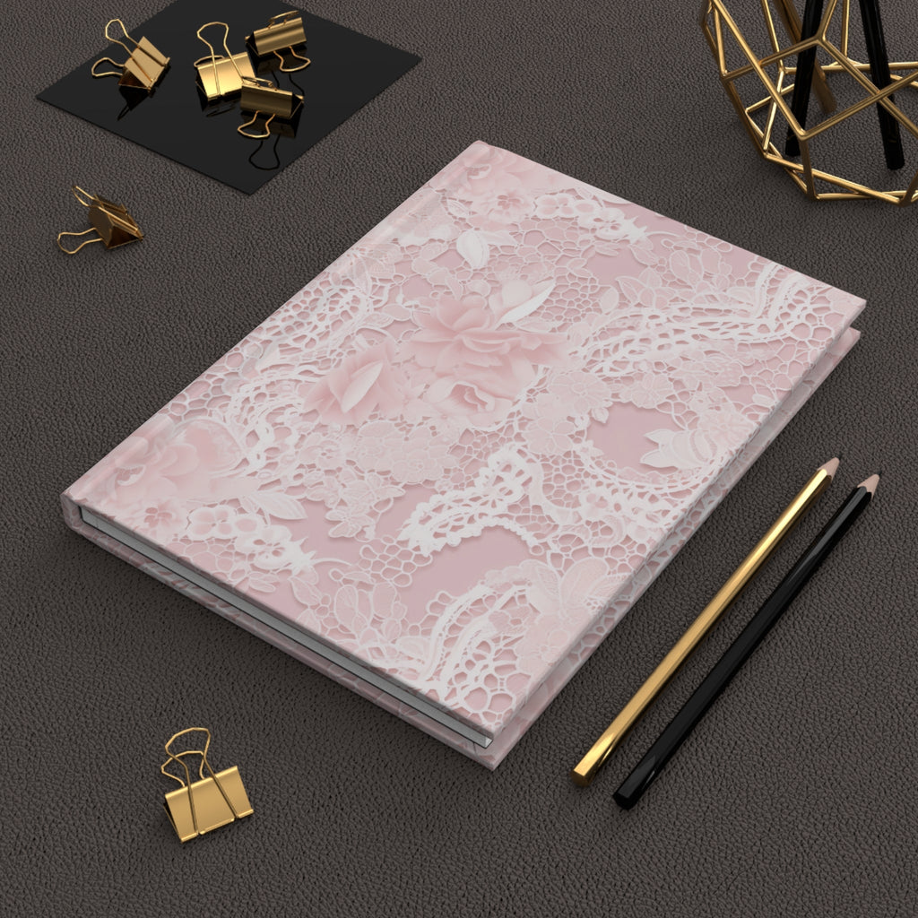 Pink floral lace hardcover journal lying flat with decorative lace floral design