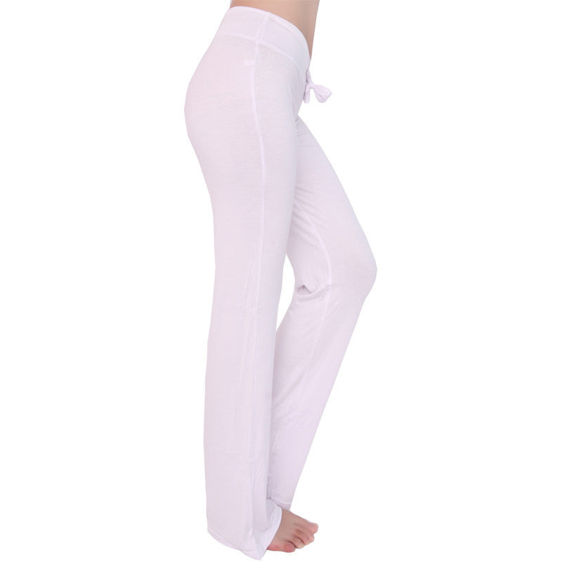 White yoga pants with drawstring waist and flared bell-bottom legs