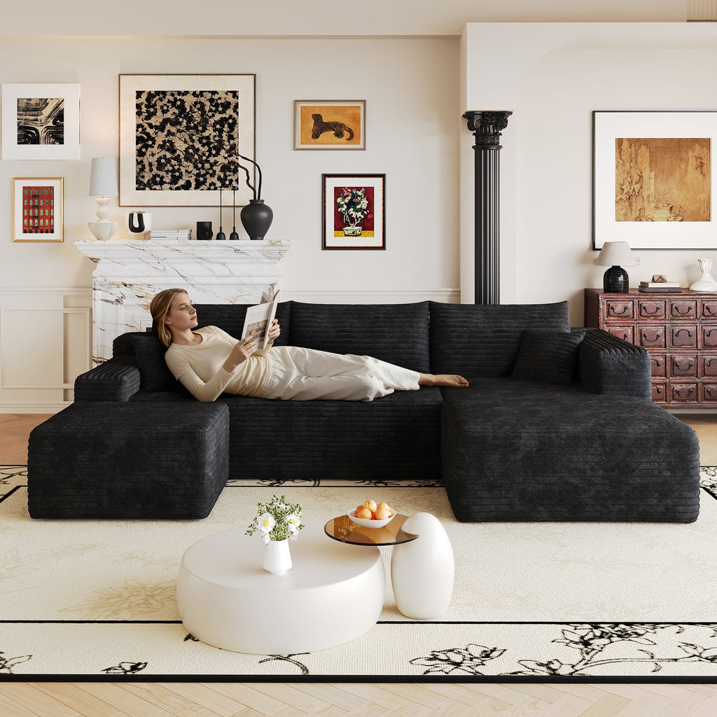Dark fabric L-shaped sectional sofa with chaise and three seat cushions.