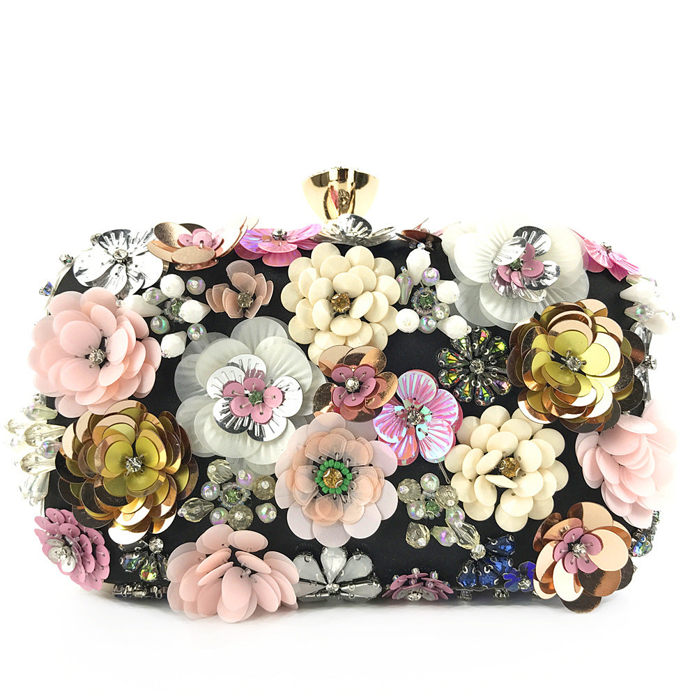 Black floral sequin clutch bag with gold-tone top clasp and chain strap