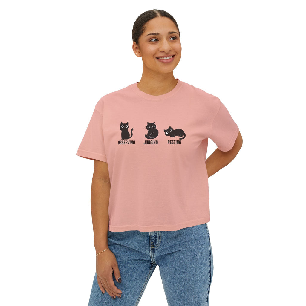 Boxy cropped cat tee in peach-pink with black cat trio graphic and text on the front