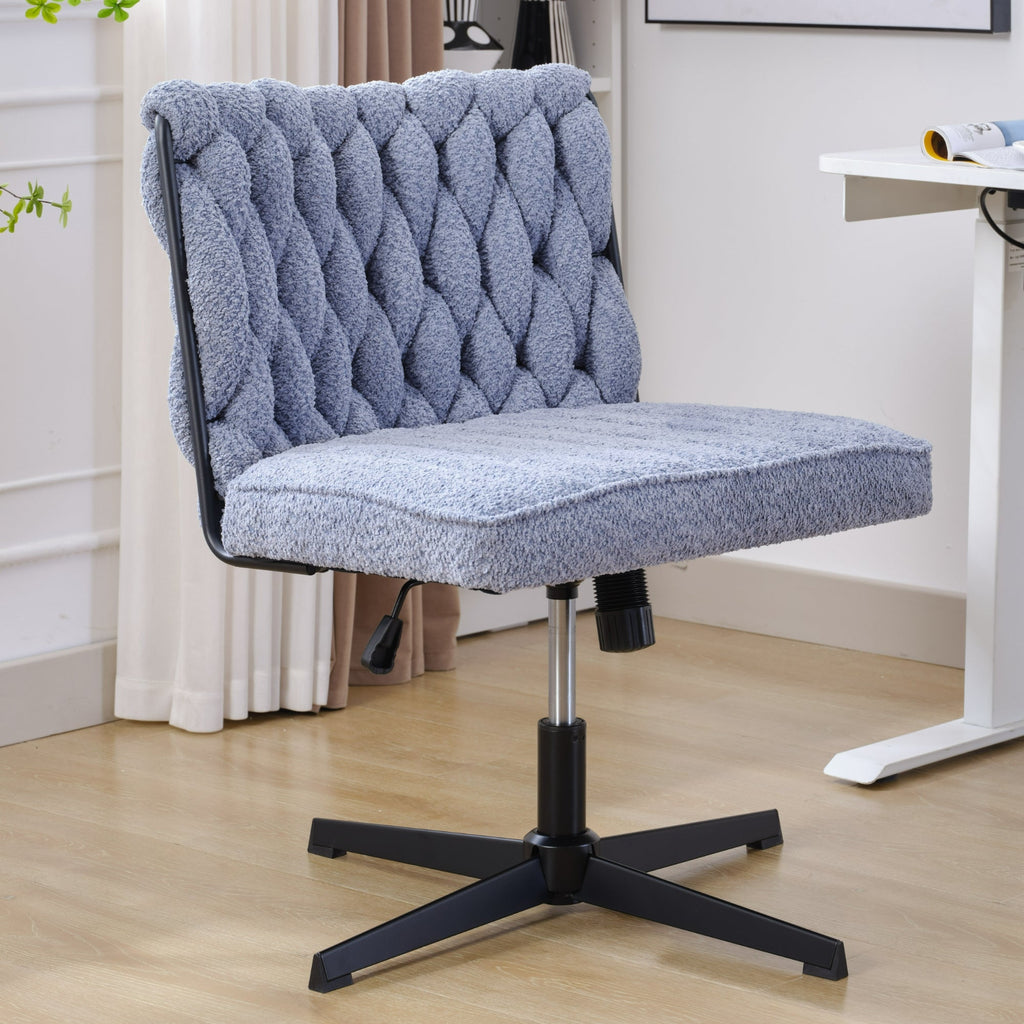 Blue armless desk chair with tufted back and padded seat, black pedestal base