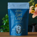 Earl Grey tea pouch, dark blue bag with light blue top and gold label